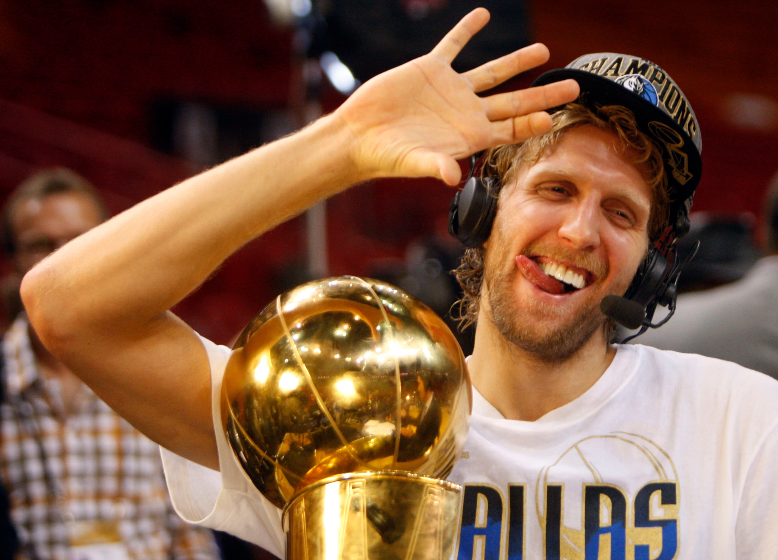 Dallas Mavericks power forward Dirk Nowitzki (41) shows how he drinks his champagne with his...