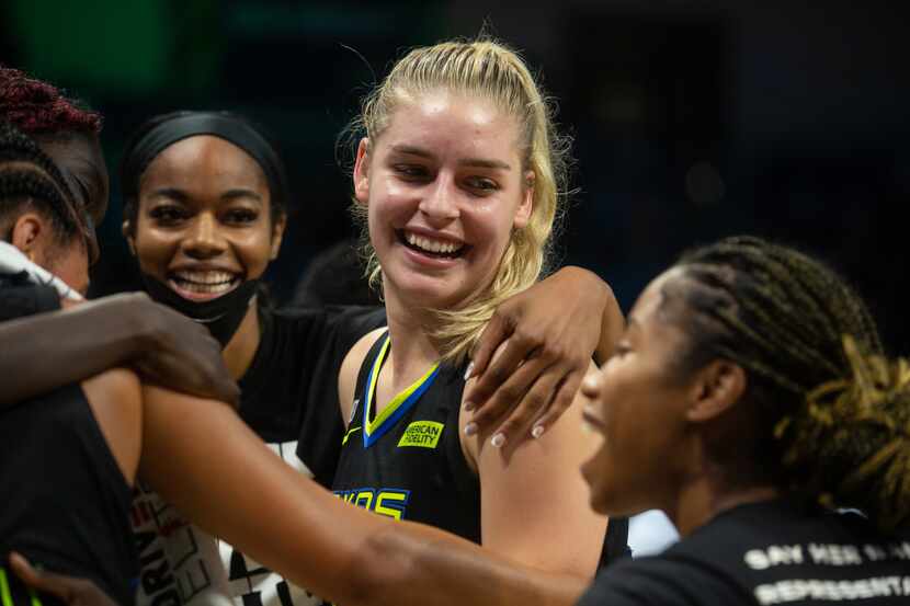 Dallas Wings center Bella Alarie (32) celebrates with teammates after their win against NY...