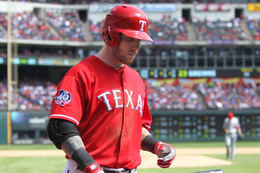 Texas center fielder Josh Hamilton returns to the dugout after striking out in the sixth...