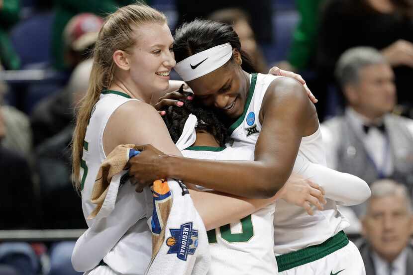Baylor's Lauren Cox, left, Kalani Brown, right, and Juicy Landrum, center, hug as they...