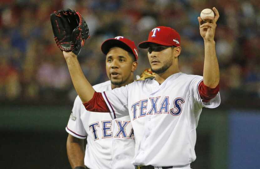 Texas Rangers shortstop Elvis Andrus, left, and pitcher Martin Perez are pictured during...