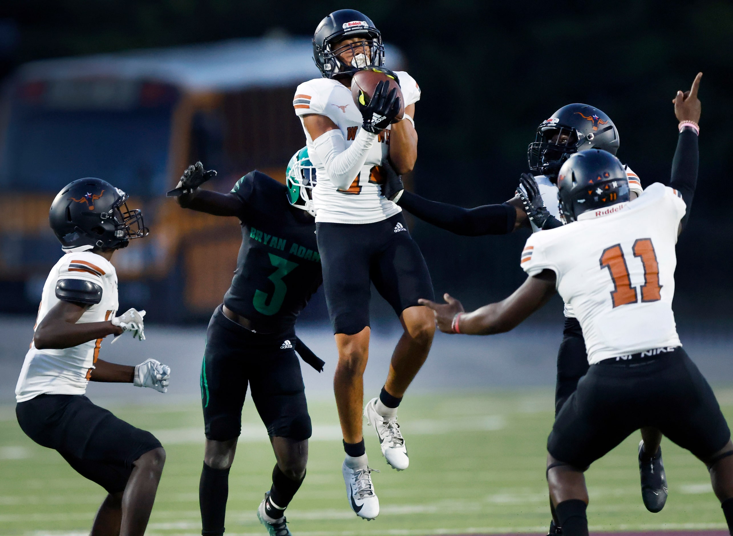 W.T. White safety Damion Borges (14) intercepts a Bryan Adams tipped pass during the first...