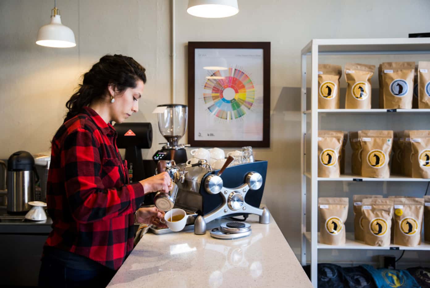 Bar manager Tiffany McAnarney makes a cappuccino at Noble Coyote Coffee Roasters across the...