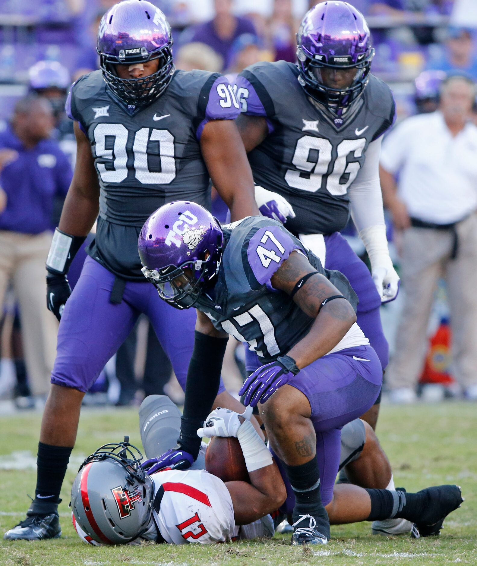 TCU linebacker Paul Dawson (47), defensive tackle Terrell Lathan (90) and defensive tackle...