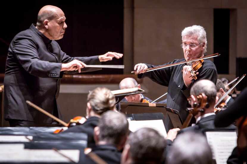 Under the baton of conductor Jaap van Zweden violinist Pinchas Zukerman performs with the...