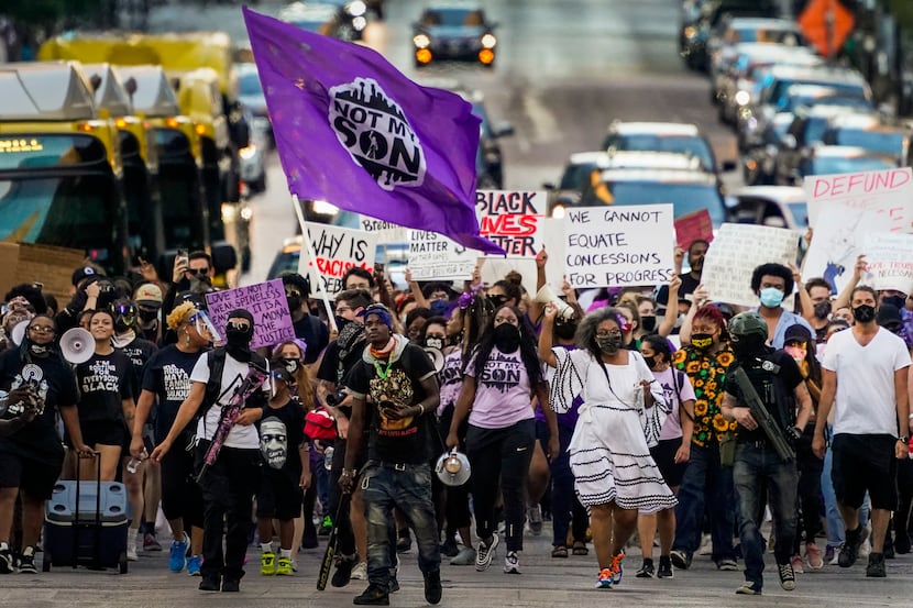 Demonstrators march down Elm Street downtown during the Not My Son organization's "100 Women...