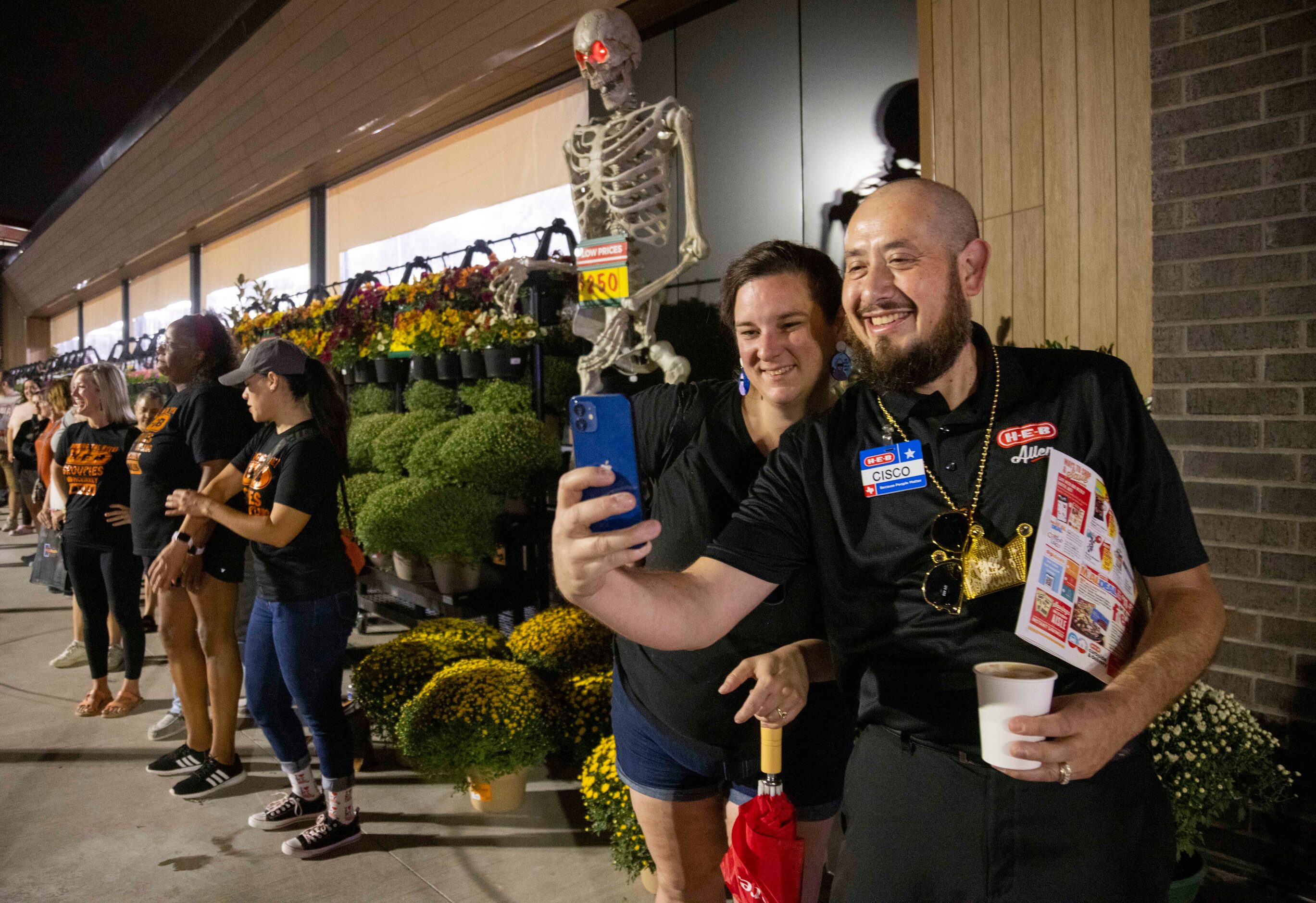 (From left) Ashlei Trammell, who’s been in line since 3pm yesterday, takes a selfie with...