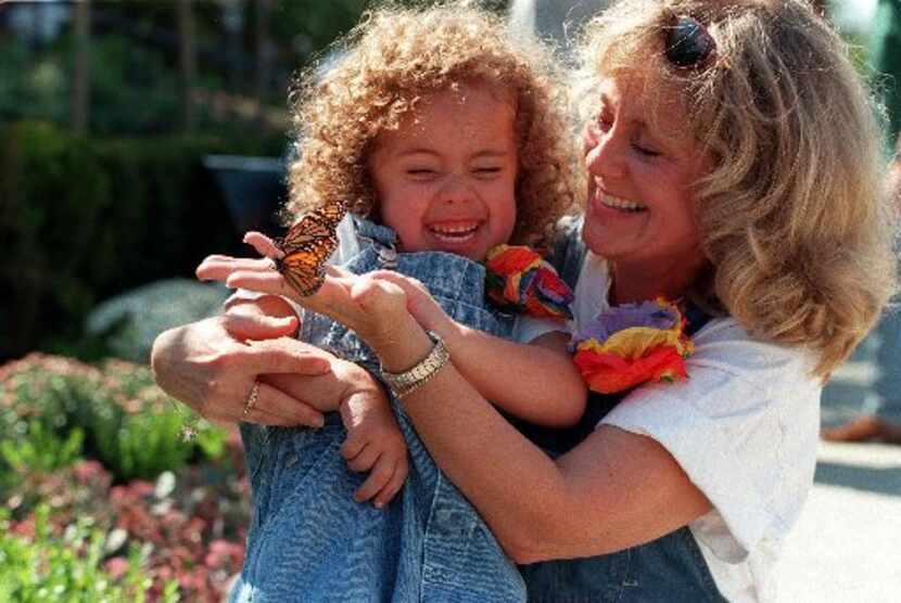 Amy Powell shows her granddaughter Ashton  Powell, 4, two of the over 1.200 butterflies...