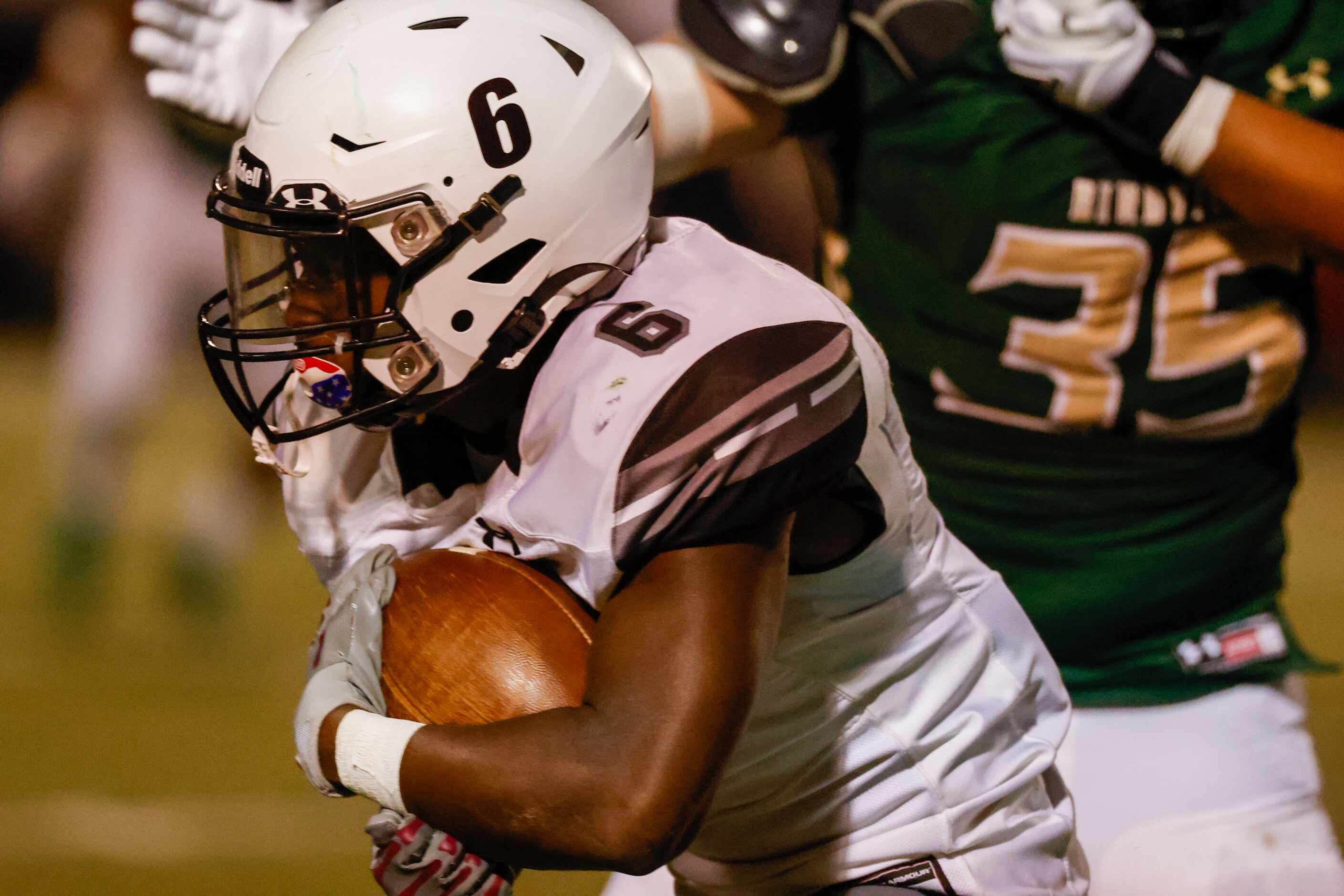 Mansfield Timberview running back Javeon Madison (6) dodges Birdville defenders in the first...
