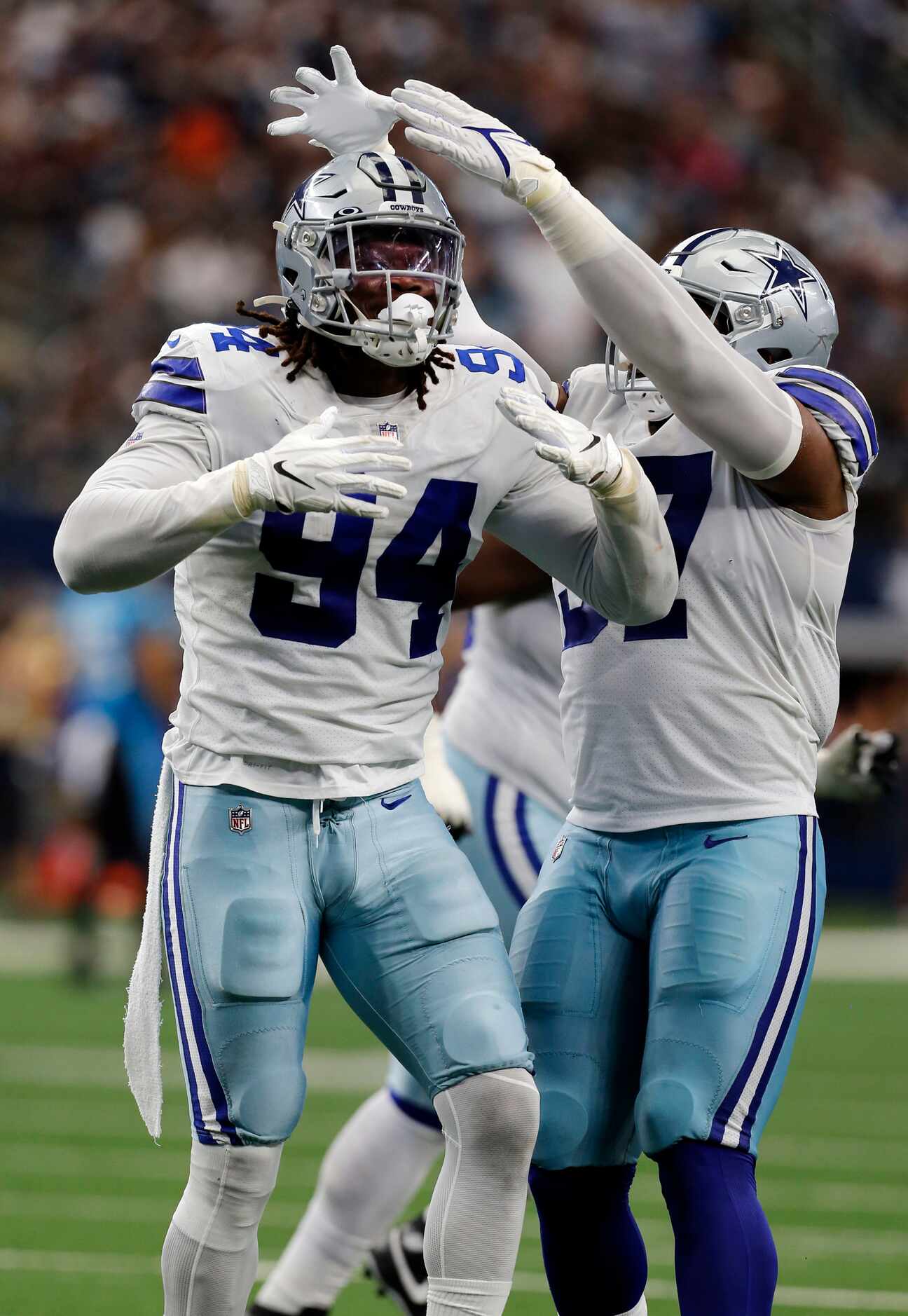 Dallas Cowboys defensive tackle Osa Odighizuwa , right, places an imaginary crown atop the...