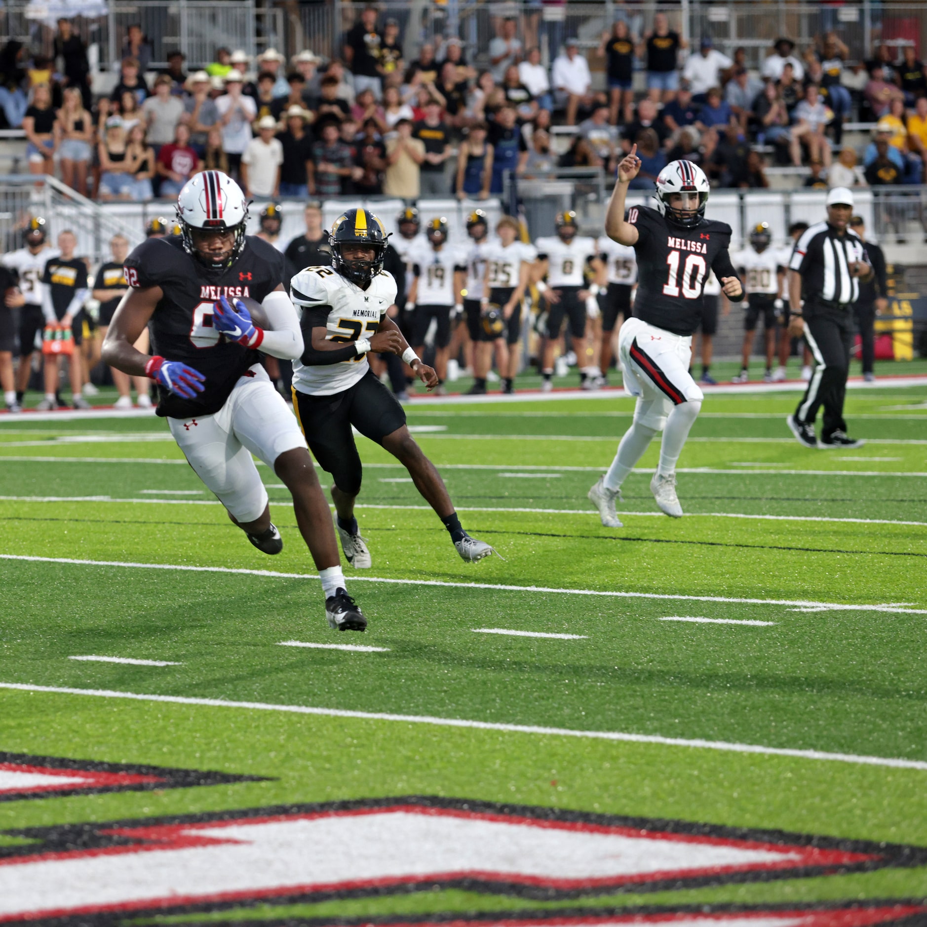 Melissa player #82 Reese Carter runs in for a touchdown as Memorial player #22 Doug McCloud...