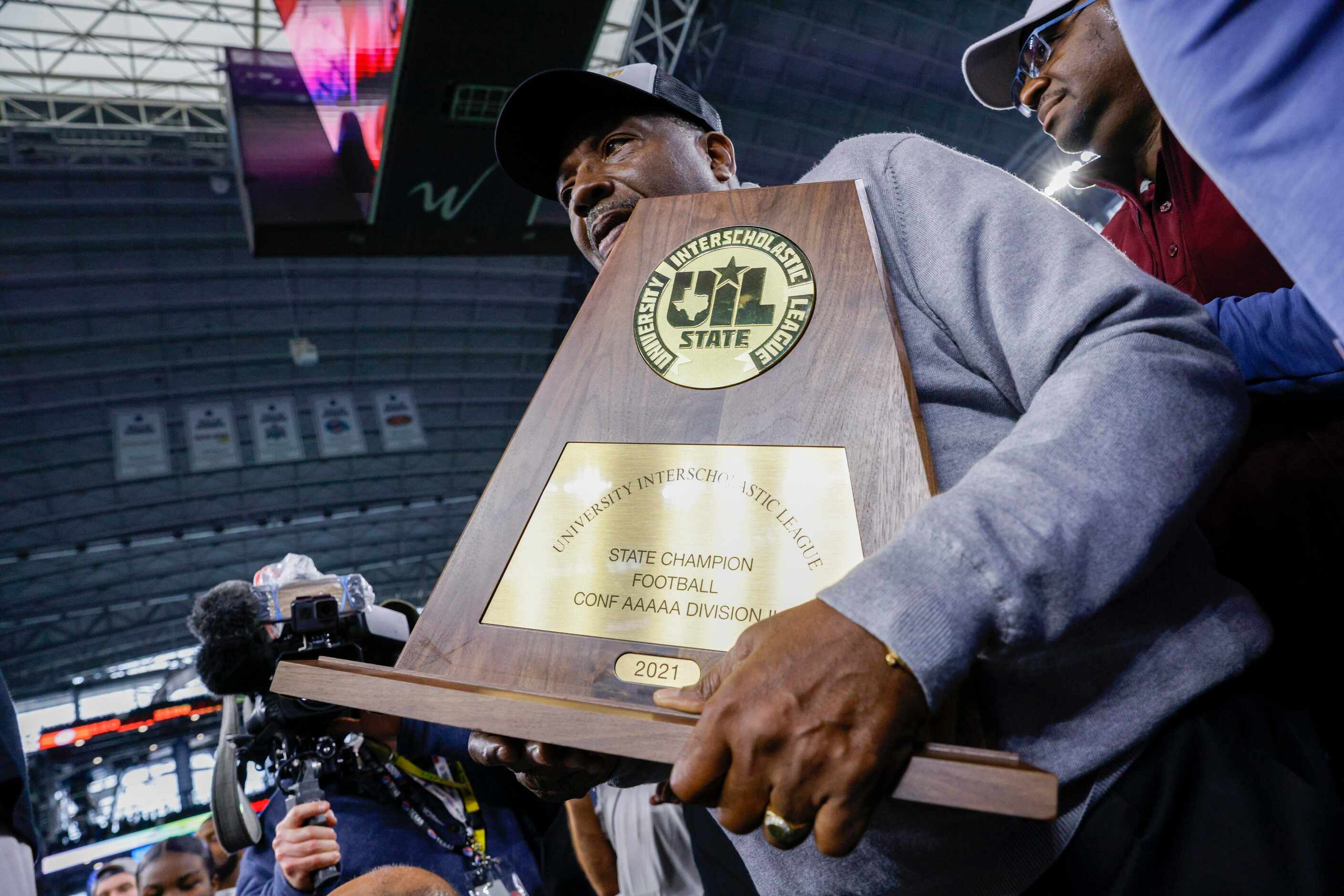 State Sen. Royce West holds the championship trophy before a presentation after the Class 5A...