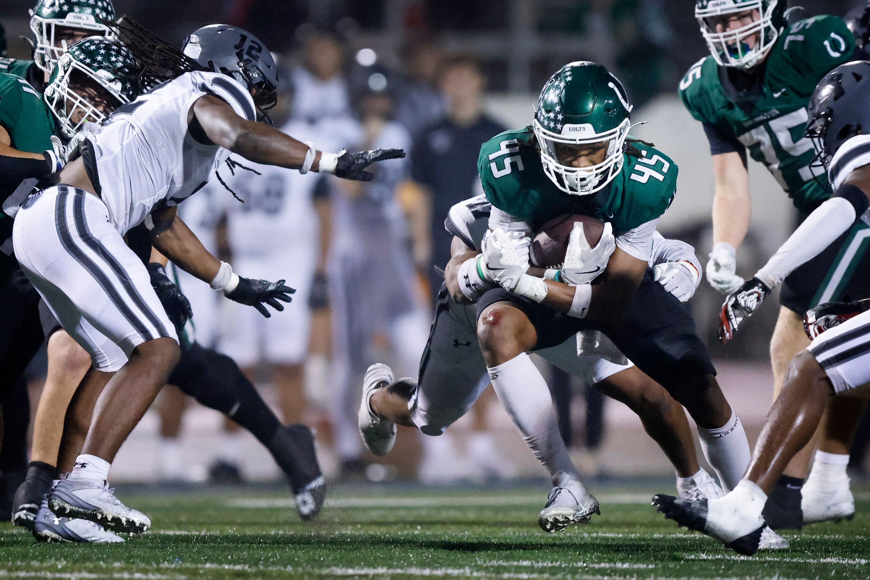 Arlington High wide receiver Isaiah Robertson (45) carries the ball against Arlington Martin...