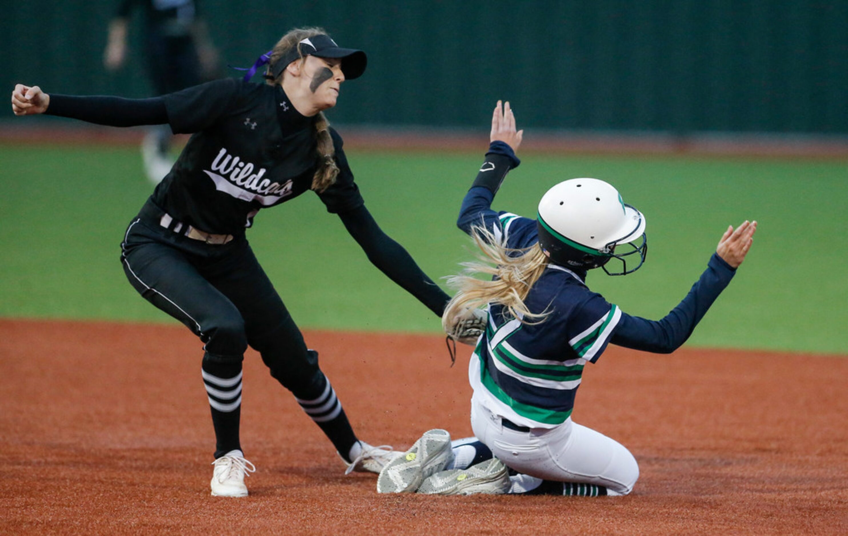 Denton Guyer shortstop Morgan Medford, left, tags out Eaton's Amanda Ambrosy on an attempted...