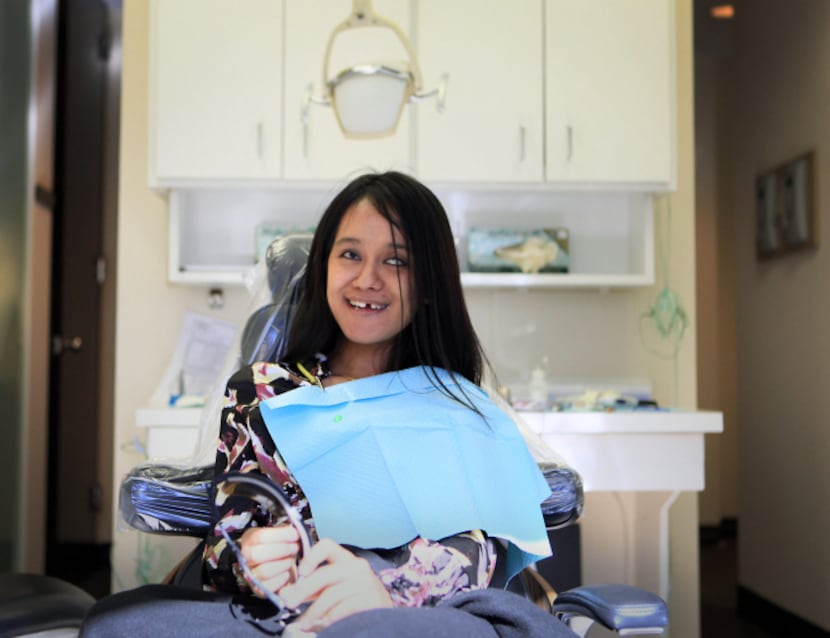 Robina Rayamajhi waited earlier this month for installation of a temporary crown, one of the...