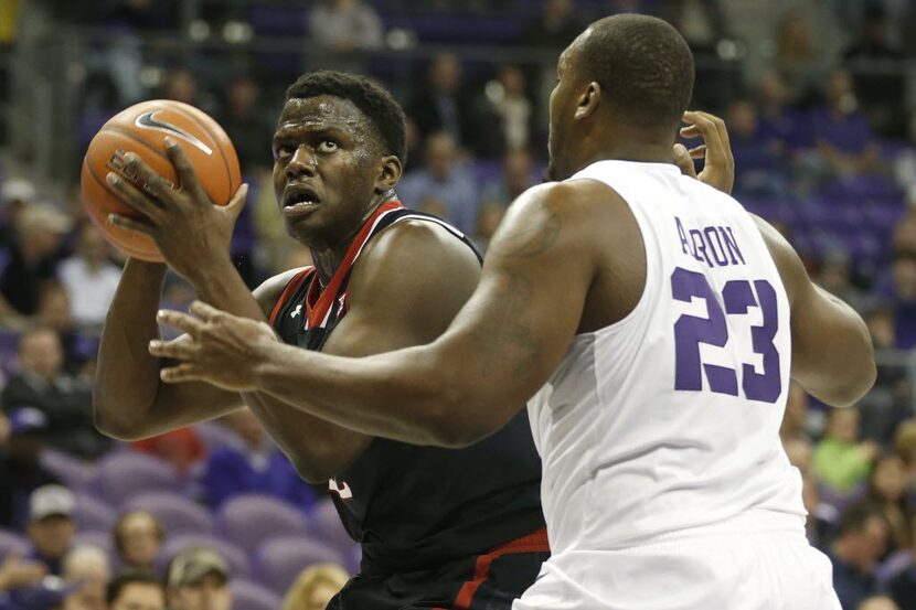 Texas Tech center Norense Odiase (32) looks to shoot as TCU forward Devonta Abron (23)...