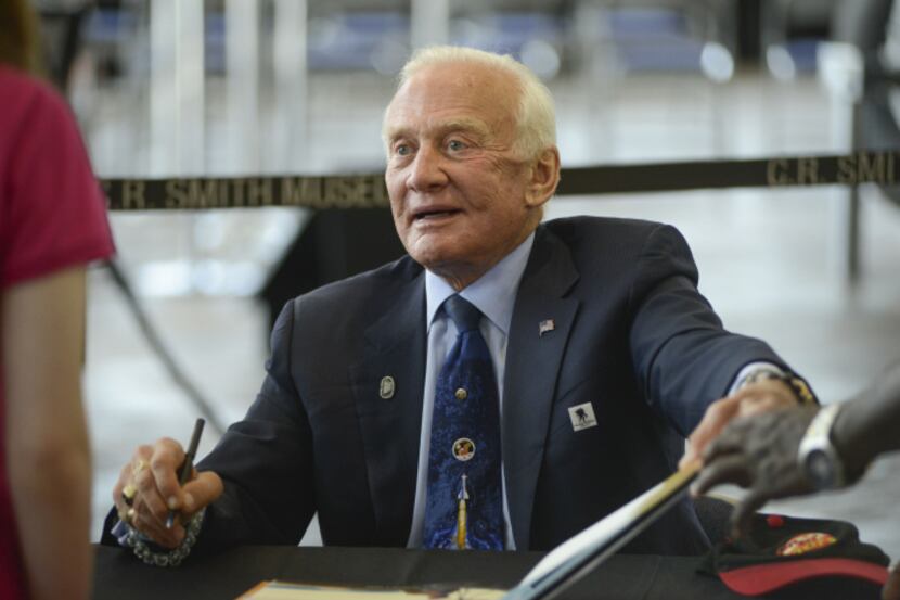Astronaut Buzz Aldrin talked with a fan on Saturday during a 20th anniversary celebration at...