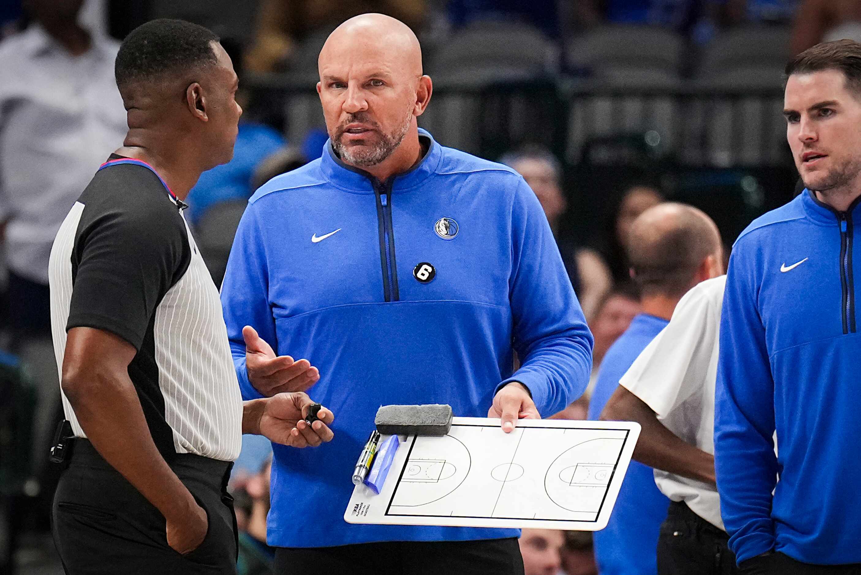 Dallas Mavericks coach Jason Kidd talks with a referee during the first half of an NBA...
