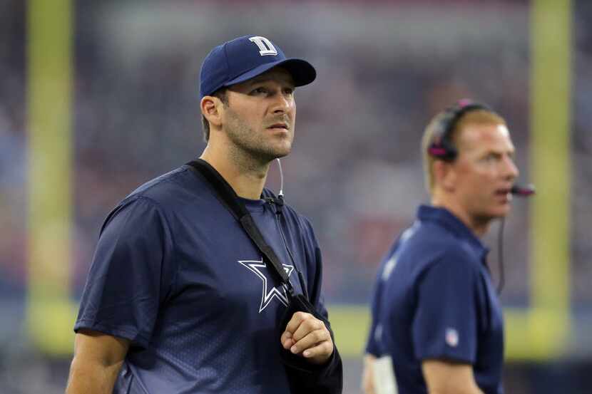 Dallas Cowboys' Tony Romo watches from the sideline during the first half of an NFL football...