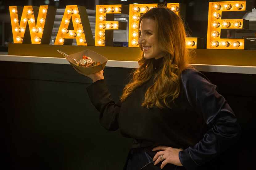 Erica Batterman poses with a Press Company Waffle in front of the company's sign at the Food...