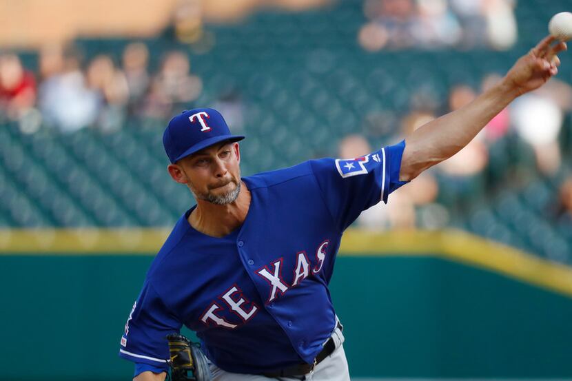Texas Rangers pitcher Mike Minor throws against the Detroit Tigers in the first inning of a...