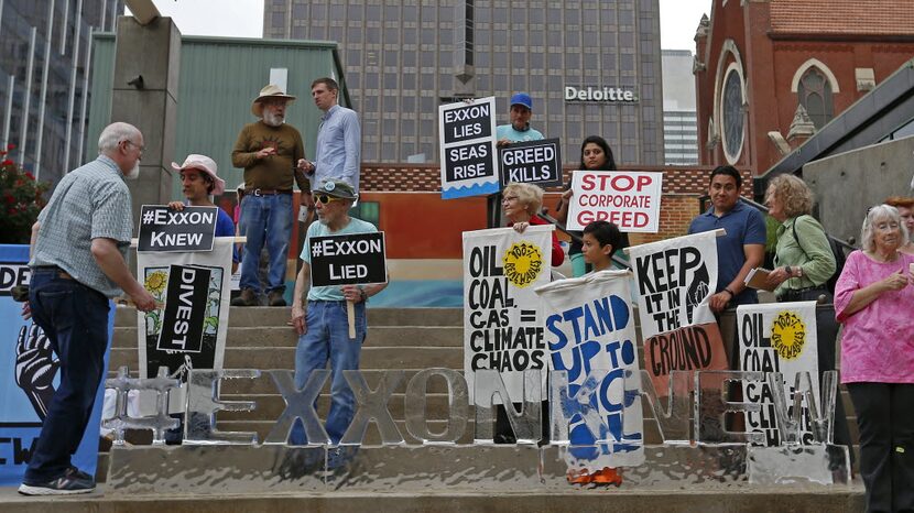 People protest across from the Morton H. Meyerson Symphony Center where the Exxon Mobil...