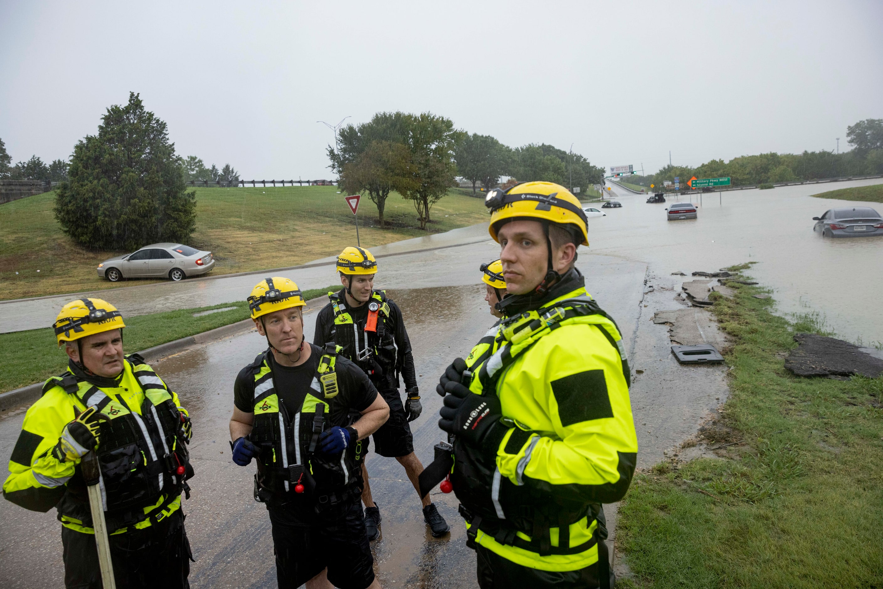 Members of the Mesquite Fire Department survey the flooded area of Interstate 635 Service...