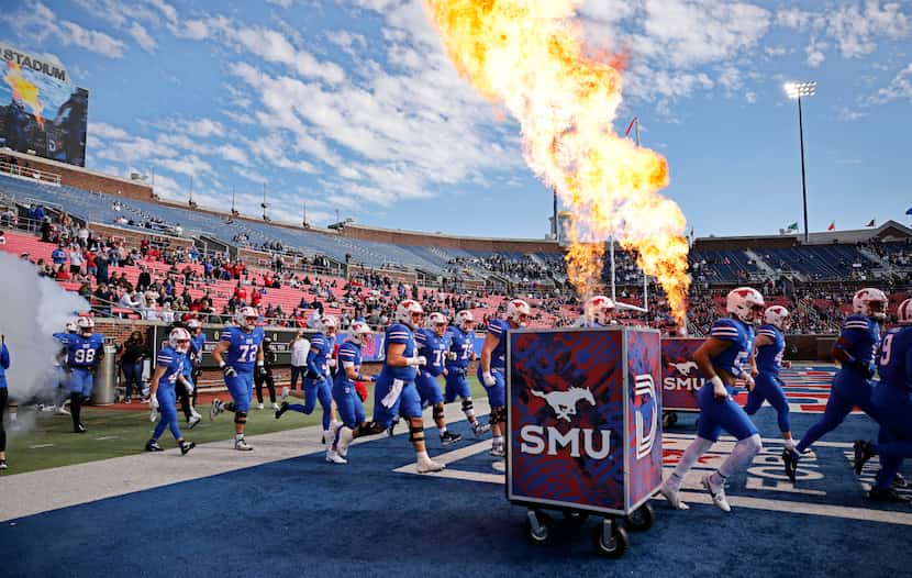 SMU players run into the field before during an NCAA college football game against the Navy...