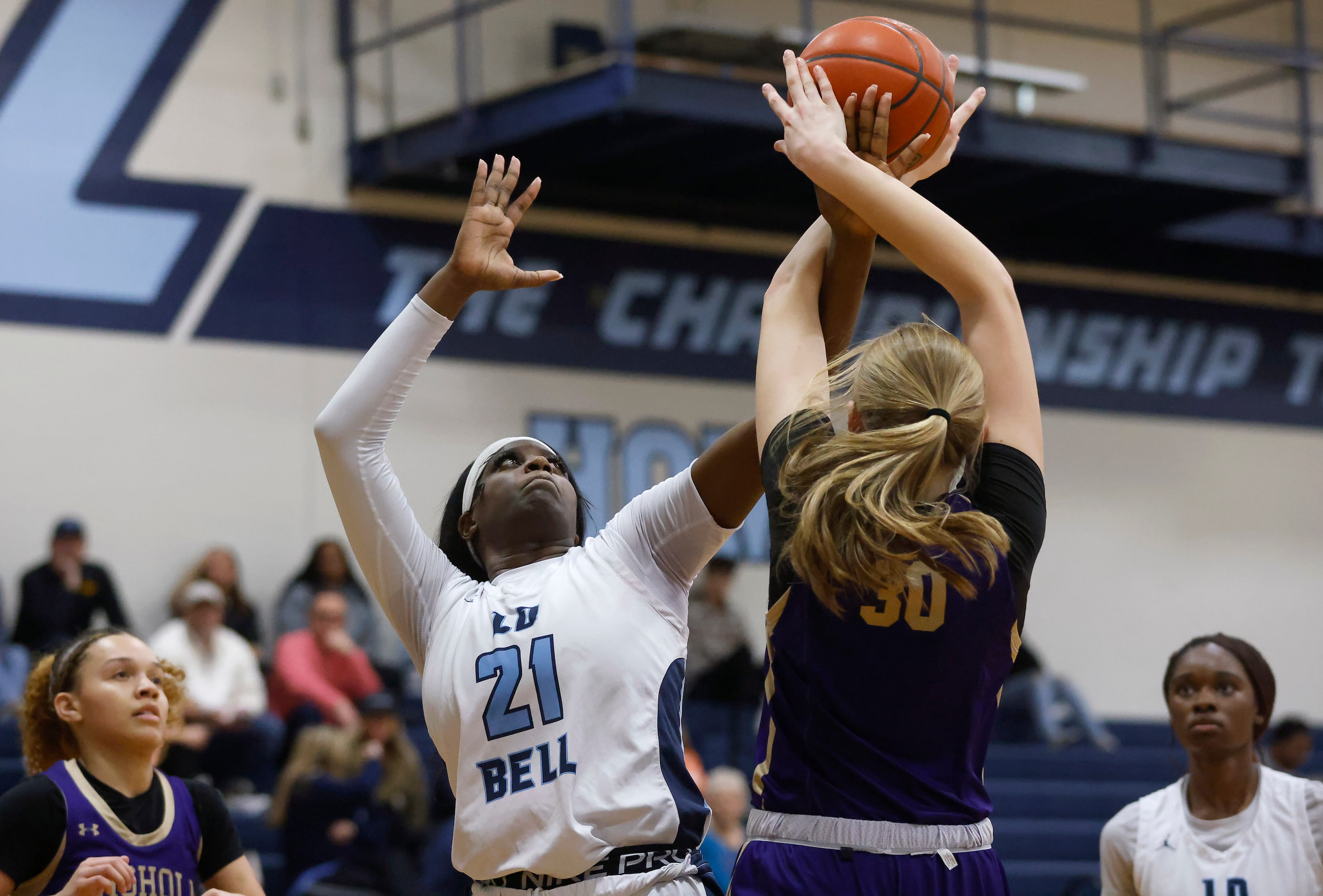 Hurst L.D. Bell forward Gracie Oma (21) and  Saginaw Chisholm Trail center Claire Blakley...