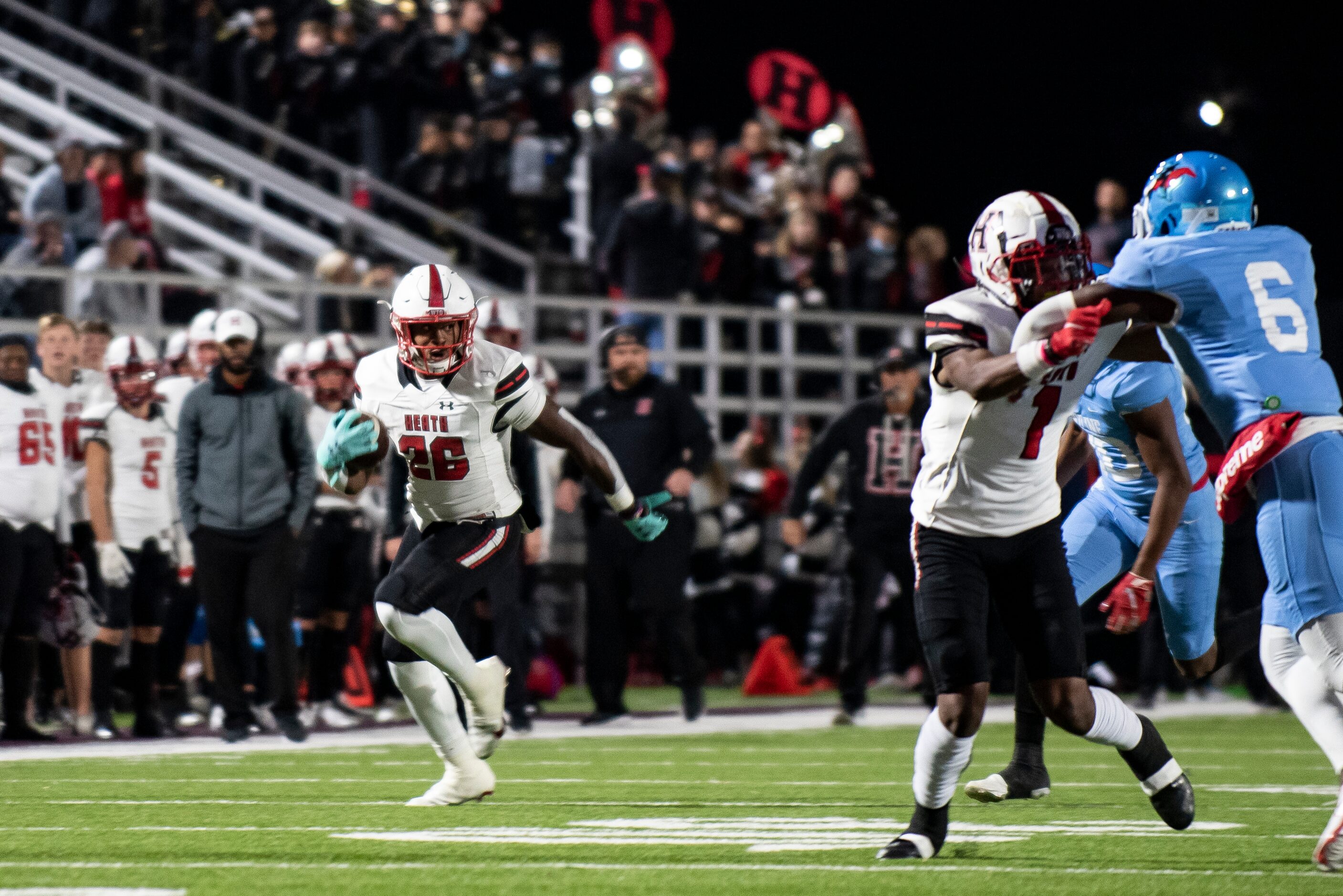 Heath senior Zach Evans (26) sprints down the field during a District 10-6A game between...