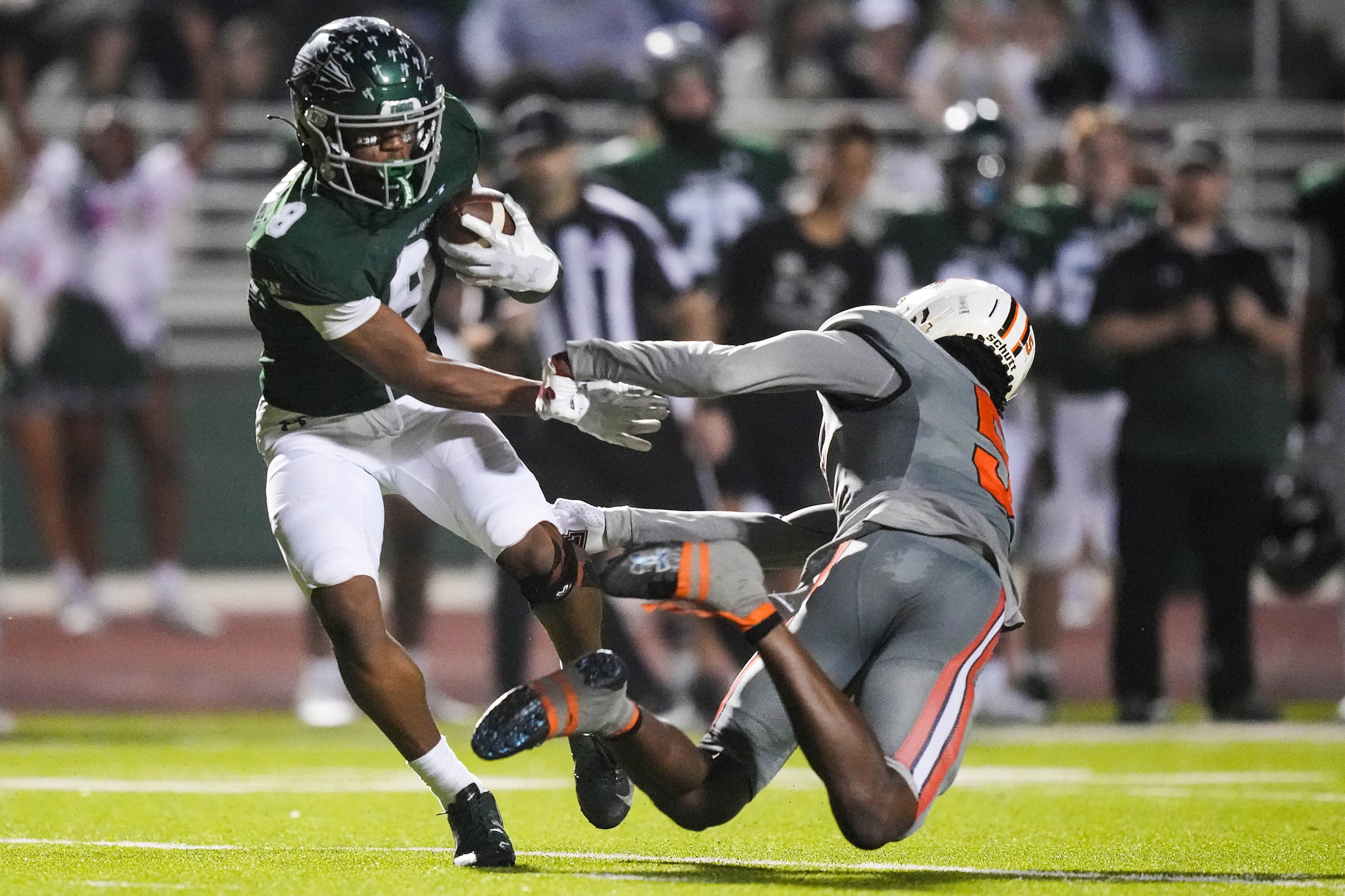 Waxahachie’s Kohen Brown (8) gets past Lancaster defensive back Braylan McDonald (5) on a...