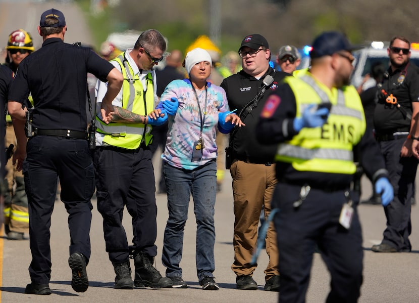 A woman is transported from a fatal school bus crash on Texas State Highway 21 near Caldwell...