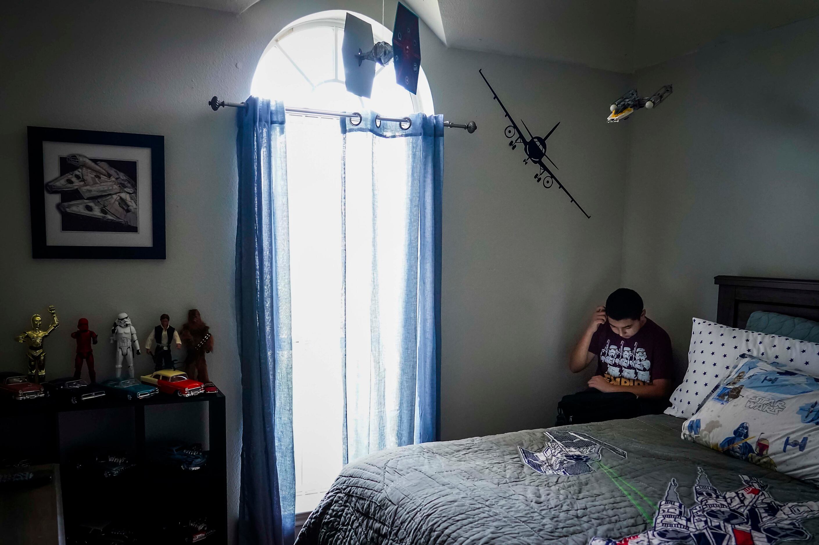 Francisco Cabrera, 13, does school work for a math class on a computer at his bedroom at the...