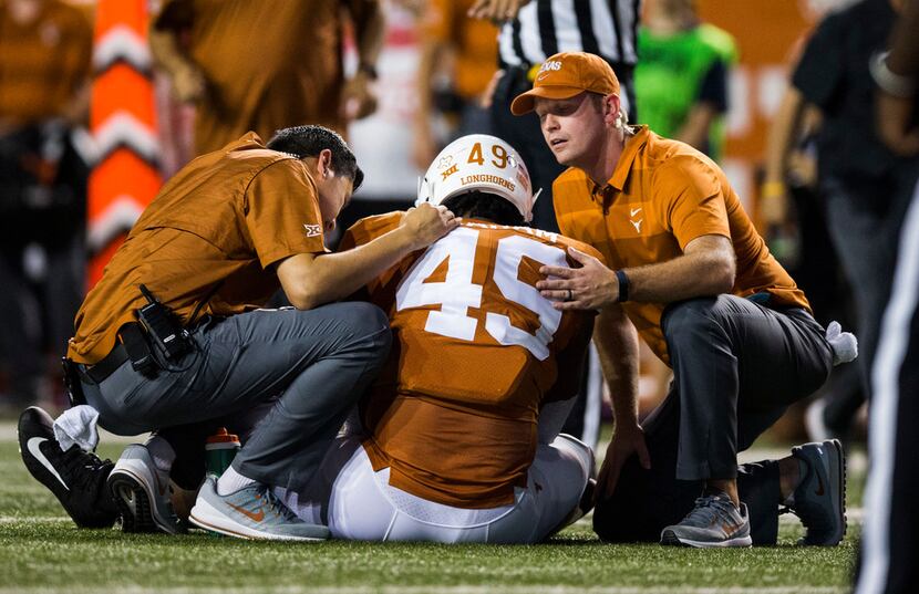 Texas Longhorn defensive lineman Ta'Quon Graham is checked out after an injury during the...