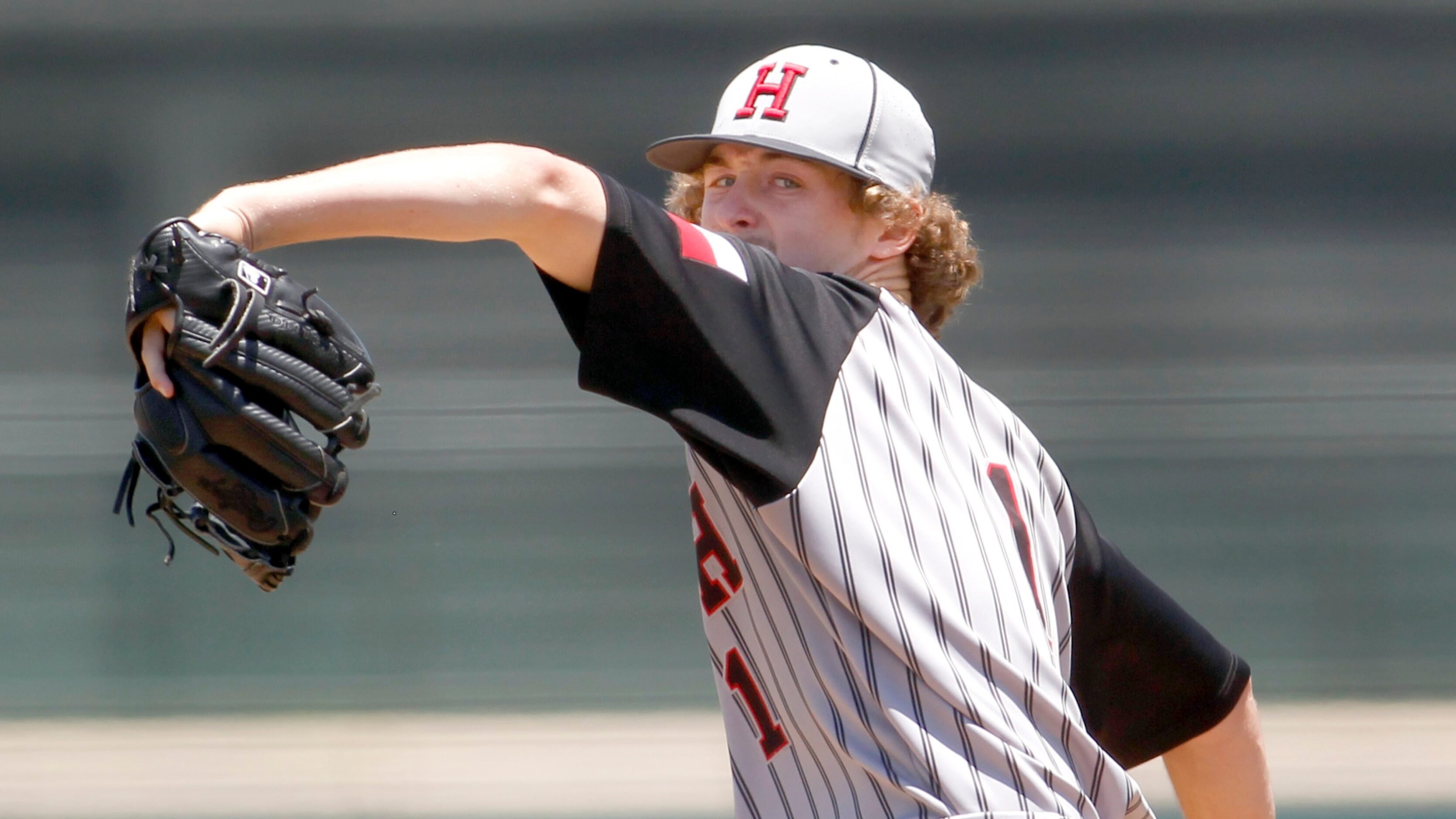 Rockwall Heath pitcher Baylor Baumann (1) delivers a pitch to a Rockwall batter during the...