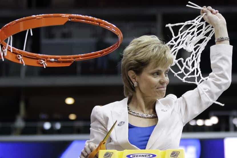 Baylor coach Kim Mulkey waves the cut net following the NCAA women's college basketball...