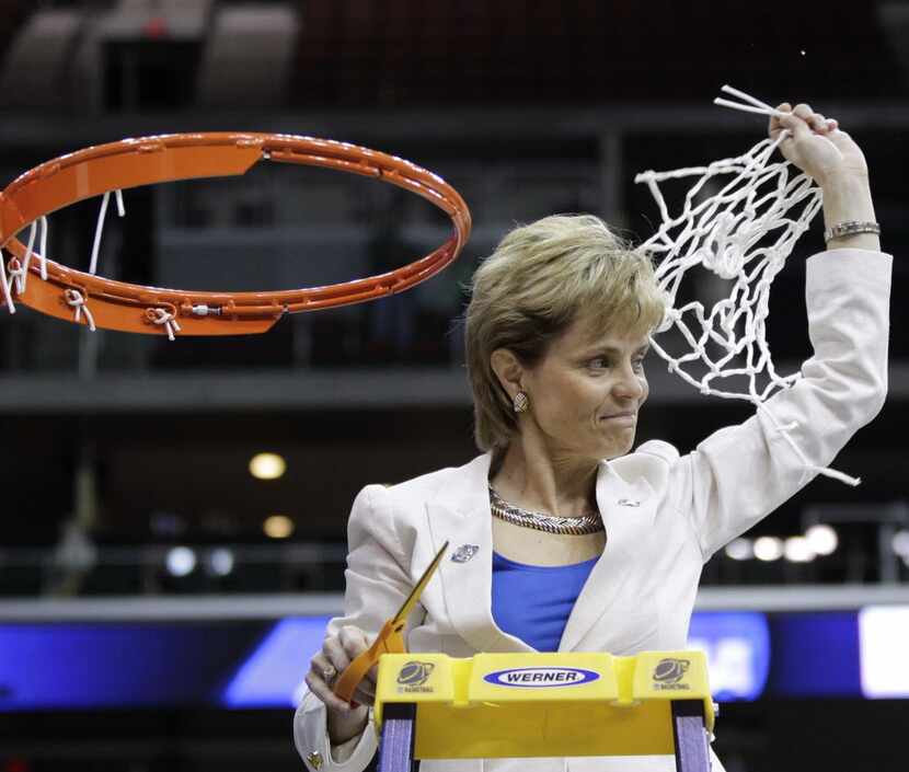 Baylor coach Kim Mulkey waves the cut net following the NCAA women's college basketball...