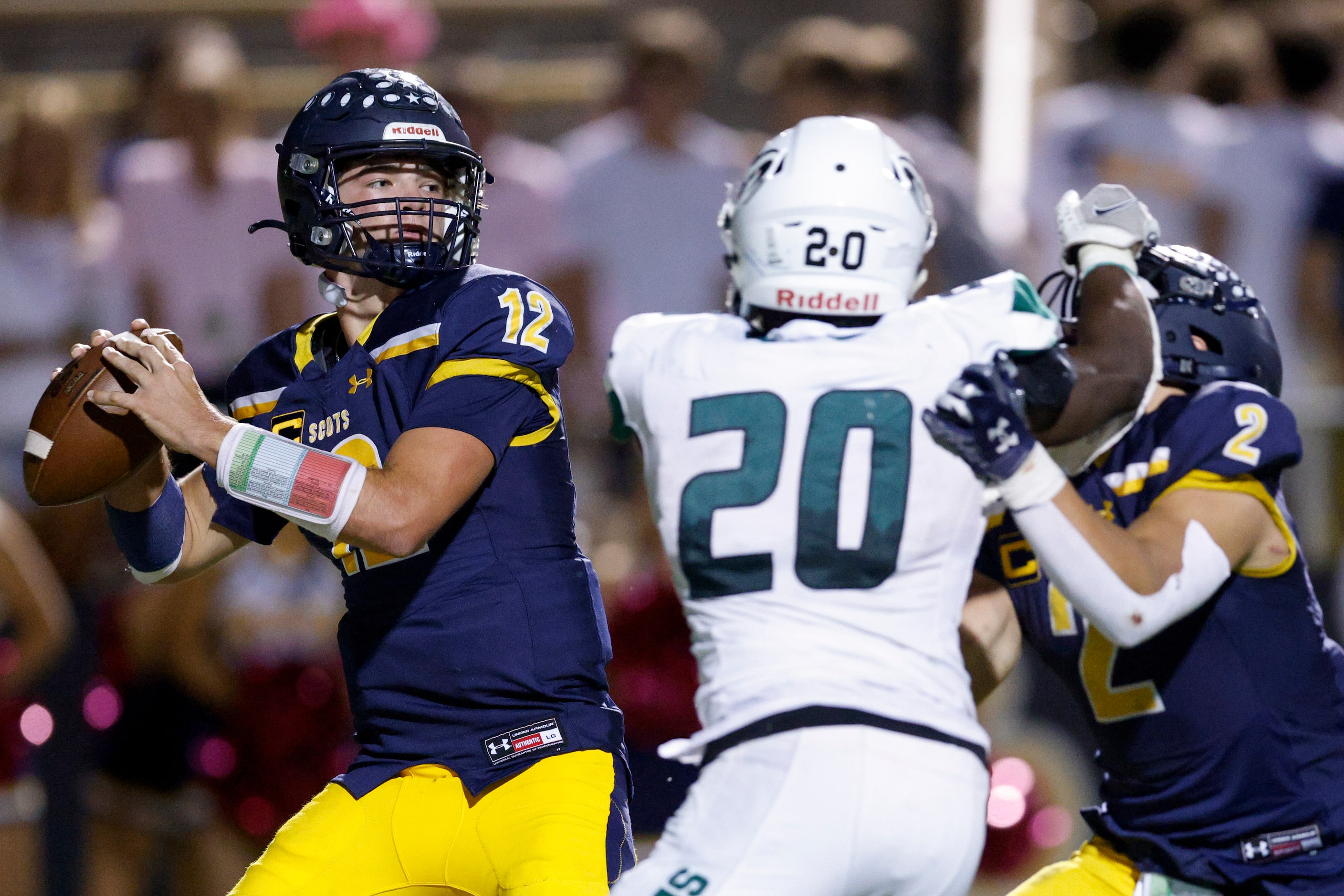 Highland Park quarterback Warren Peck (12) throws under pressure from Richardson Berkner...