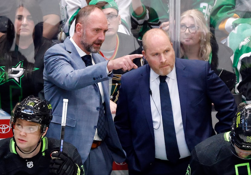 Dallas Stars head coach Pete DeBoer (left) confers with assist Steve Spott during the second...