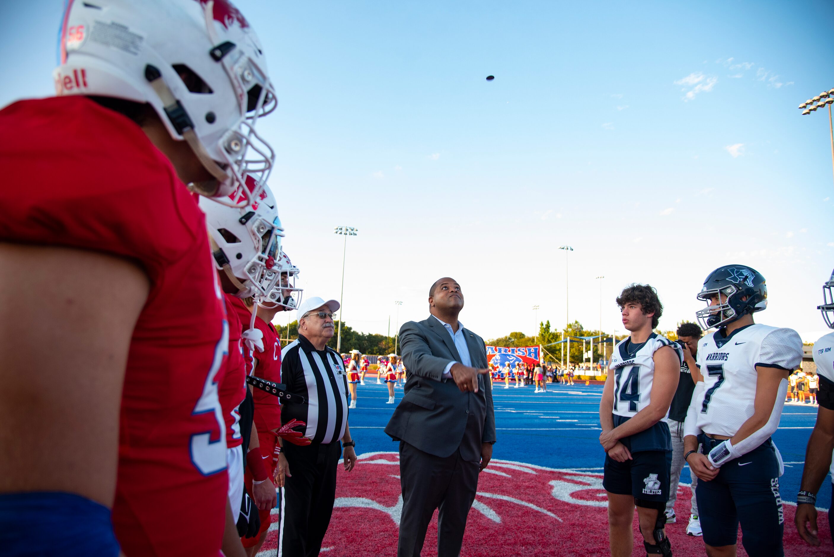 Dallas Mayor Eric Johnson flips a coin to determine who gets the ball on the first...