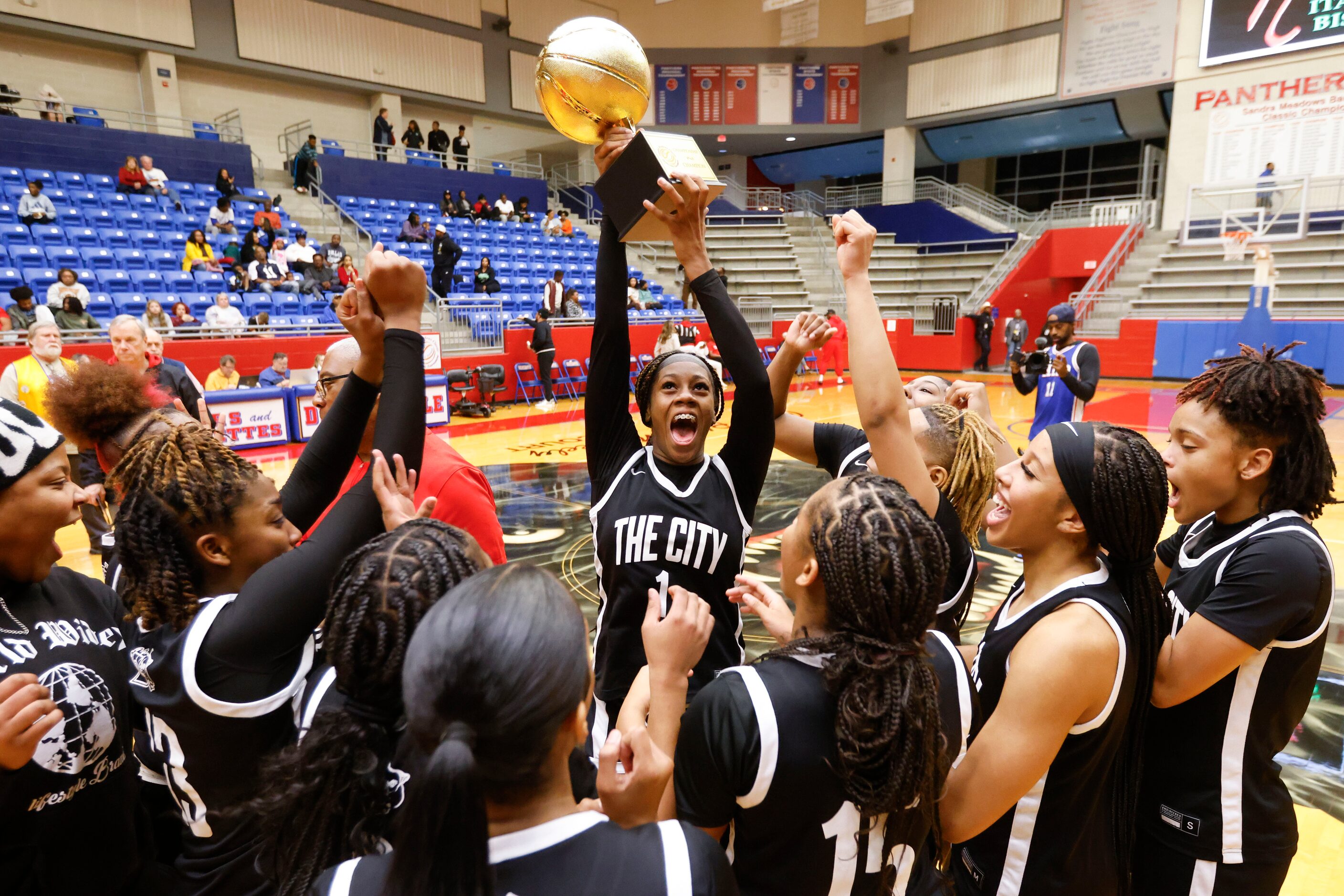 Duncanville high’s Mariah Clayton (center) and her teammates celebrates following their...