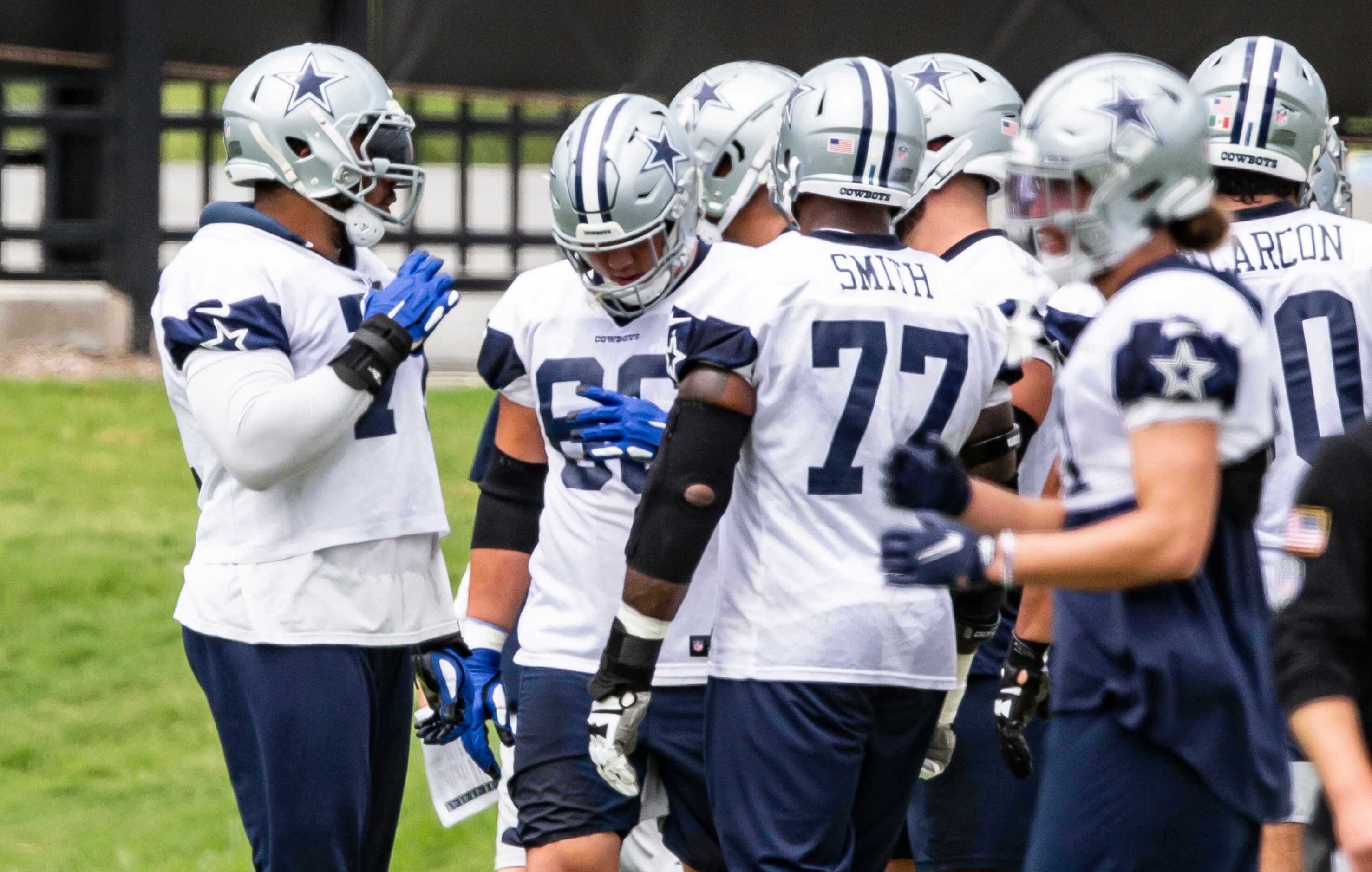 Dallas Cowboys offensive tackle La'el Collins, left, gathers with his teammates during...