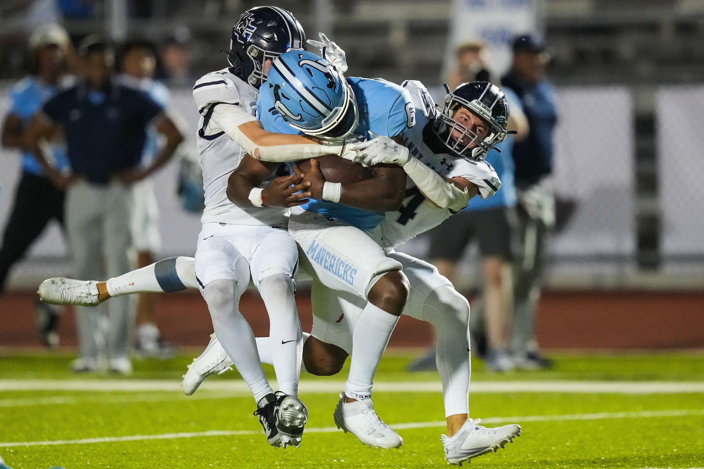 Frisco Emerson running back Nick Clark (6) is brought down by Prosper Walnut Grove defensive...