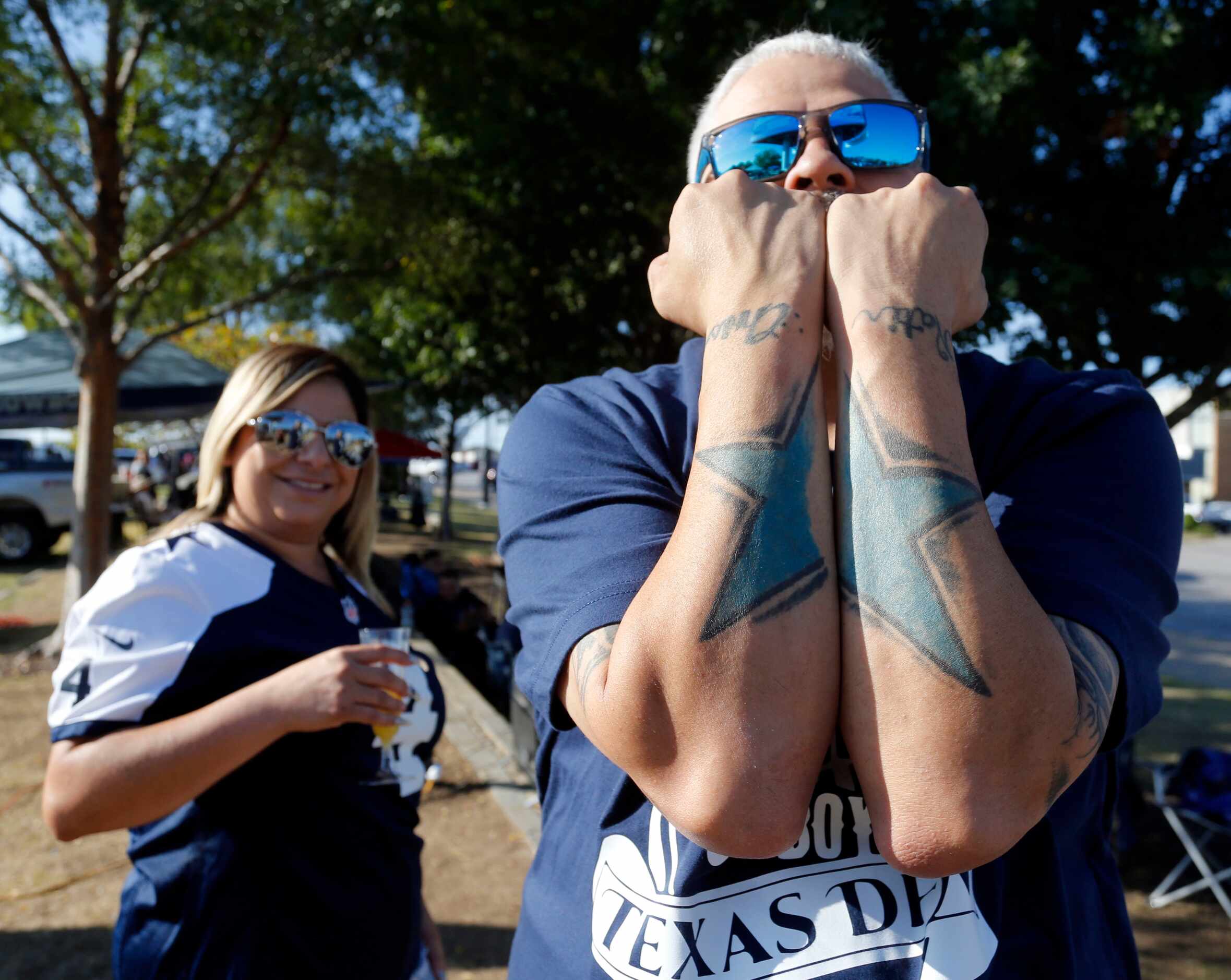 Nancy Lara, of Duncanville, watches friend Chis Palacio, of Ft. Worth, display his Dallas...