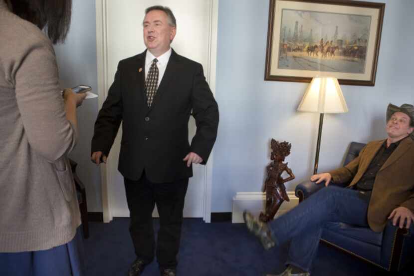 U.S. Rep. Steve Stockman (standing) of Friendswood and musician Ted Nugent, a National Rifle...