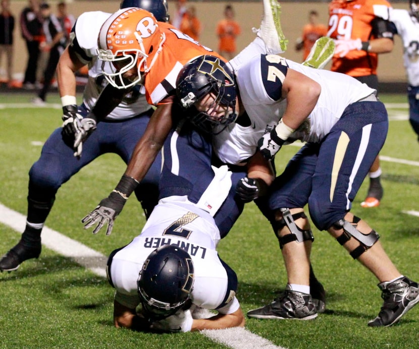 (TXHSFB) Jesuit's Conner Lampher (7) tumbles into the end zone behind the block of teammate...