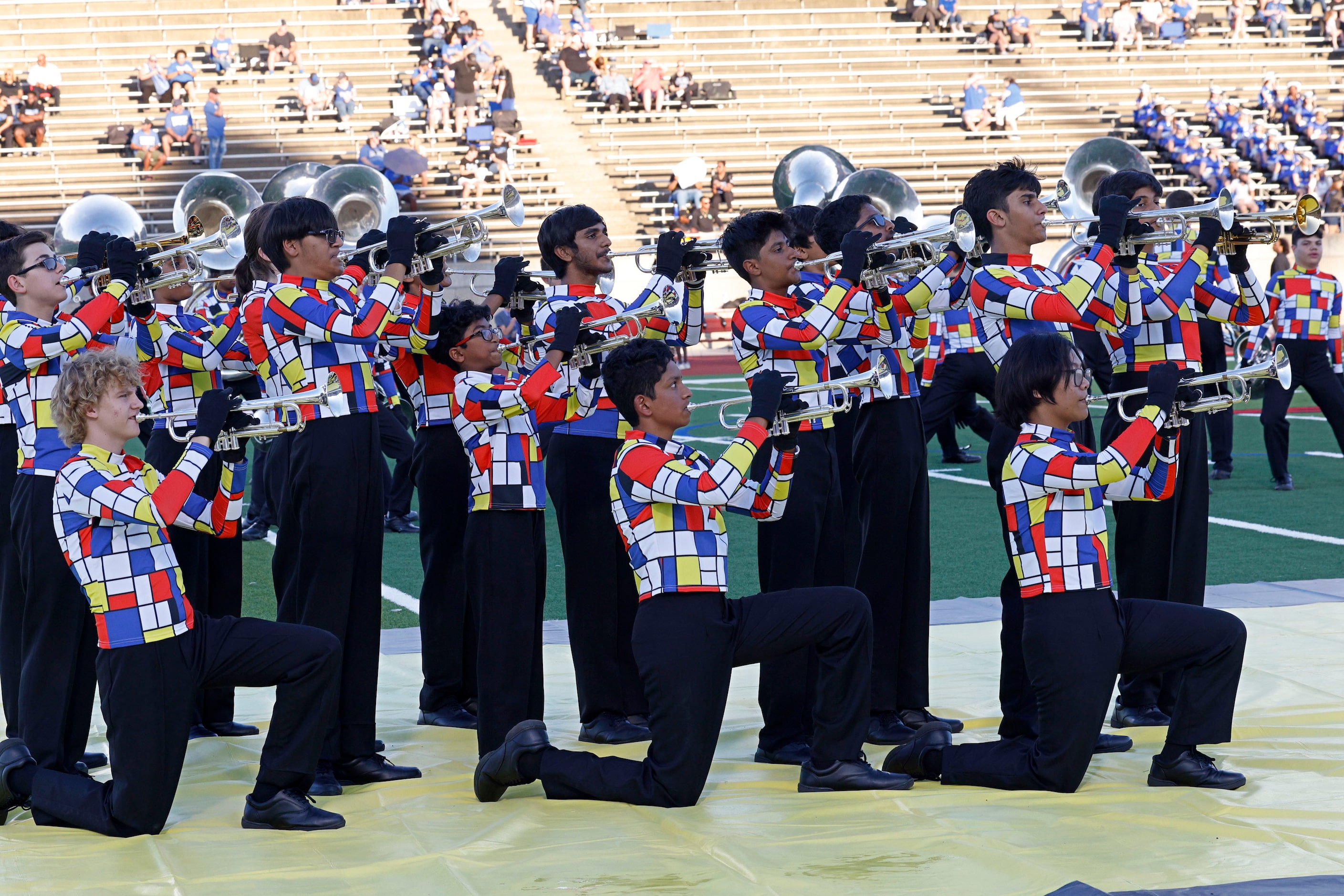 Coppell’s marching band members perform before a high school football game against Hebron,...