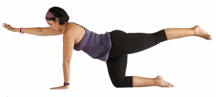 Personal trainer Sylvia Bernal demonstrates the bird dog, which is also a yoga pose. 