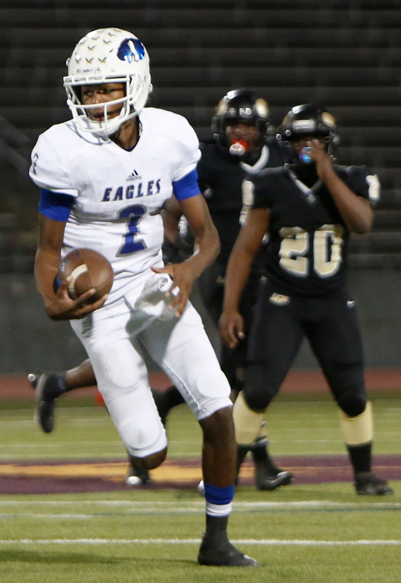 Wilmer Hutchins quarterback Andre Henderson (2) leaves Dallas Pinkston defenders at a...