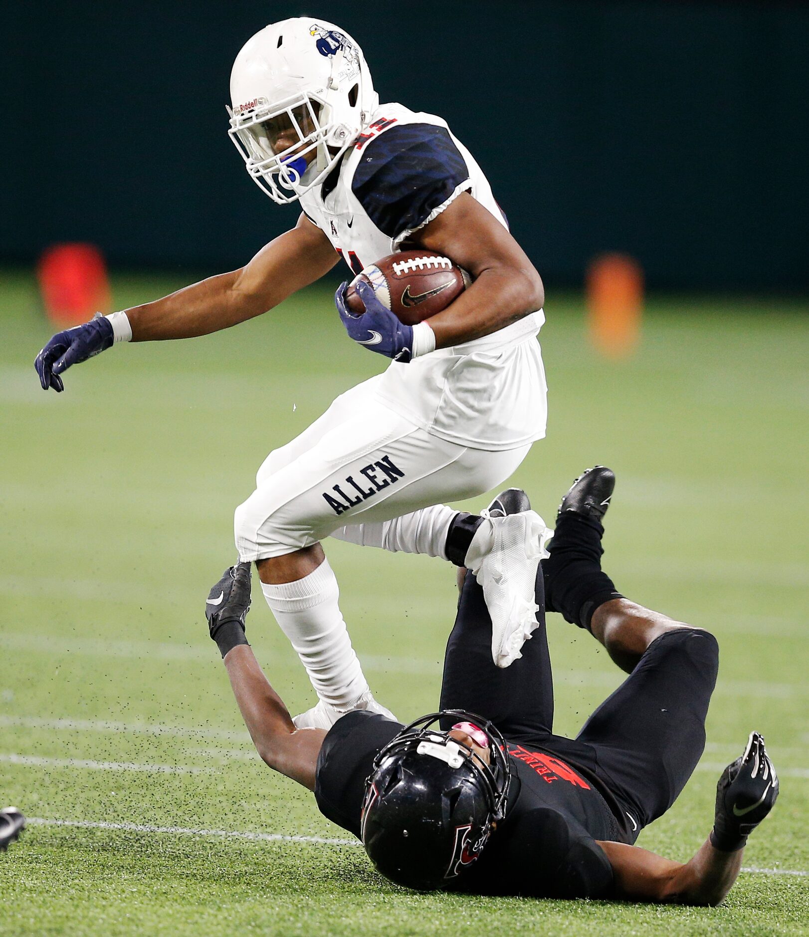 Euless Trinity senior defensive back LD Martin (8) tackles Allen senior wide receiver Jordan...